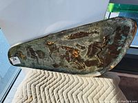 Full view of the copper art panel showing all four dancing musicians on a textured rectangular background with patina.