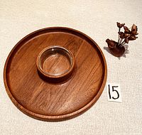Top view of teak serving tray with circular glass insert, showing its round shape and smooth wood finish.
