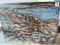 Front view of the signed acrylic painting showing landscape of Georgian Bay with rocks and water in earth tones and blue shades.