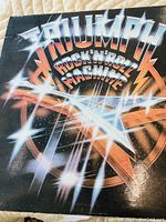 Front cover of the Triumph Rock'N'Roll Machine vinyl album showing the title and graphic design.
