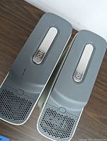 Close-up of two detachable hard drives labelled 'HDD' attached to Xbox 360 consoles.