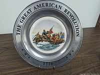 Front view of commemorative plate with Washington crossing the Delaware illustration and text on rim.