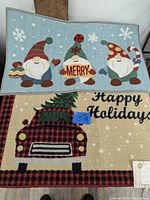 Photo showing two Christmas-themed rugs: one with gnomes and 'MERRY' text, the other with a plaid truck and 'Happy Holidays' text.