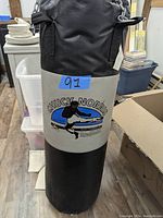 Front view of heavy bag showing Chuck Norris martial arts logo on gray middle section