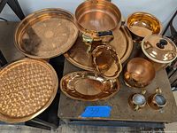 Overview of full lot including chafing dish, serving platters, bowls, and ice bucket in copper finish