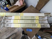 Four boxed drapery rods on table with packaging showing brand and measurements