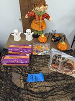 Full lot showing all Halloween decorations on display including ghosts, pumpkins, spider, scarecrow, light boxes, confetti, and fabric