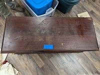 Top view of antique cedar chest showing wood finish and surface scratches.