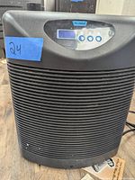 Front view of black Plunge water chiller unit showing the ribbed design and digital control panel with three buttons and display.