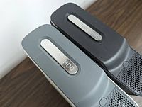 Close up of detachable hard disk drives (HDD) on two Xbox 360 consoles, showing one labeled as 120GB HDD.