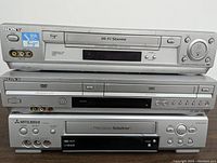Front view of the three stacked VCR units: Sony SLV-N700, Sony DVD/VHS combo, Mitsubishi TurboDrive VCR.
