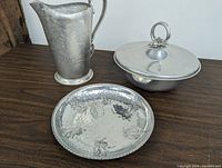 Three-piece vintage set on dark wood surface; pitcher, covered bowl, and plate showing overall design and size proportion.