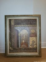 Framed lithograph showing the full artwork in a gold-tone frame, displayed upright on the floor.