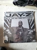 Photo of the sealed vinyl record album 'Jay-Z Vol. 3... Life and Times of S. Carter' in black and white album cover with Jay-Z wearing denim jacket and cross necklace.