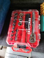 Top view of the Craftsman socket wrench tool set in a clear red plastic case showing all sockets, ratchet wrench, and extensions inside.