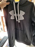 Photo of gray Under Armour hoodie showing large logo and front pocket