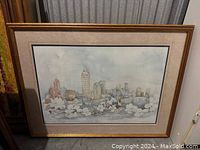 Framed watercolor print of Atlanta cityscape with floral foreground, showing overall size and framing detail.