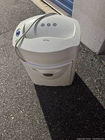 Paper shredder showing front and side with power cord and buttons