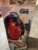 Box showing Shop-Vac Hang Up wet/dry vacuum with model and branding on front.