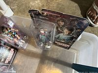 Dustin figure in blister pack with character artwork on backing card, showing minor packaging wear