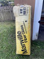 Full view of the sealed bag of Marleyville fiberglass home insulation in yellow and white woven packaging with R12 RS1/2.1 printed.