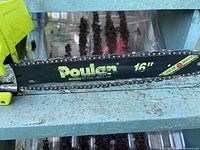 Close-up of Poulan 16-inch reduced kickback guide bar with chain.