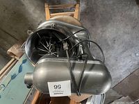 Full view of silver KitchenAid mixer from side with power cord coiled on top.