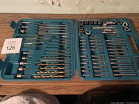 Full view of drill bits, driver bits, extension bars, and sockets in teal case.