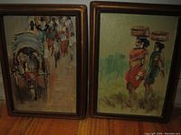 Front view of two small framed oil paintings from Bangladesh, one depicting a rickshaw scene and the other two standing figures.