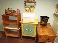 Photo of vintage kitchen storage cabinet, shelving units, and various kitchen containers including porcelain vases and breadbox