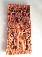 Front view showing intricate carving of Rama and Sita surrounded by flowers and vines.