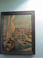 Framed vintage print showing a harbor scene with boats, framed in dark wood, overall good condition.