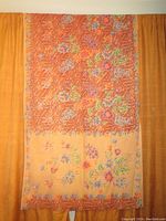 Full view of the Batik cotton curtain panel with orange and peach floral patterns.