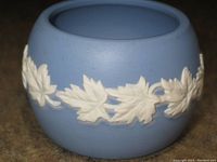 Photo of small vintage Wedgwood Jasperware pot in light blue with white maple leaf reliefs showing design and condition.