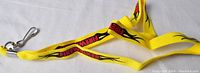 Yellow woven nylon lanyard with 'FIREWALKER' text and flame design, metal swivel hook visible.