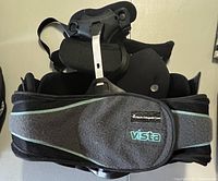 Front view of the Aspen Vista full back brace showing padded front with adjustable Velcro strap.
