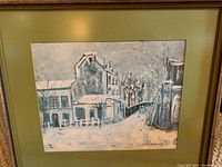 Framed Maurice Utrillo-style snowy village scene showing buildings and trees with snow.