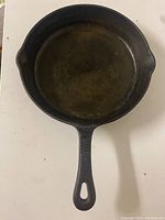 Top view of the cast iron skillet showing the cooking surface and dual pouring spouts