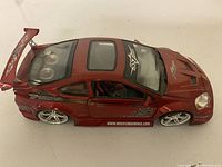 Top side view showing red paint, decals, spoiler, and wheels