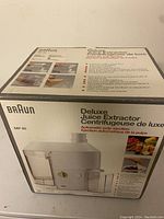 Box of Braun Deluxe Juice Extractor MP 80 with labeling and product image showing the juicer and its features.