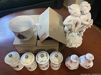 Photo showing all items including the Christmas mug, figurine, spice jars, and salt and pepper shakers on a table