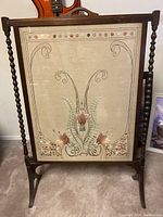 Full front view of tapestry mounted in wood frame with spiral side supports.