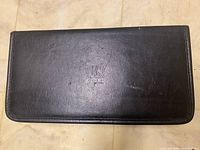 Closed black leather travel putter bag with embossed HS Golf logo on cover.