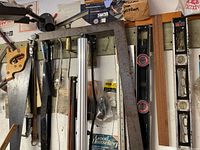 Image showing saws, framing square, and aluminum levels hung on wall