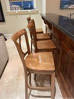 Four stools positioned at home bar showing overall set and height.