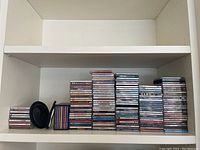 Overview of stacked CDs on shelf