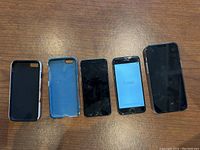 All three iPhones and three protective cases arranged on a table