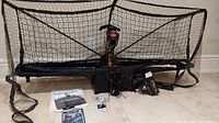 Full lot overview showing robot, net, paddles, balls, control box, and manual