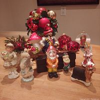Front view of the assortment displaying figurines, ornaments, and decorative balls on a wooden table.