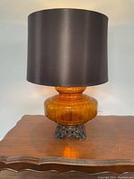 Full lamp on wooden table showing form and shade